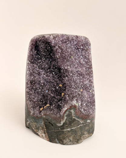 Natural amethyst geode displaying a crystalline interior and distinctive agate banding