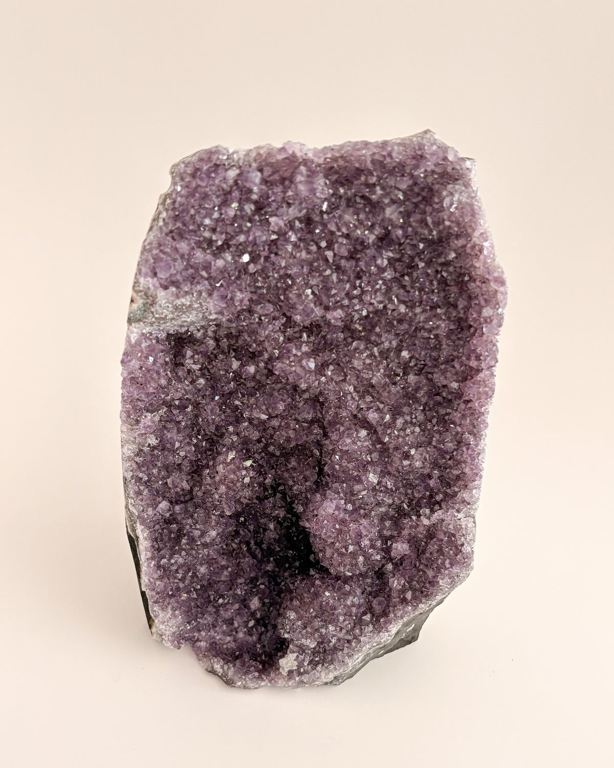Natural amethyst geode displaying a crystalline interior and distinctive agate banding