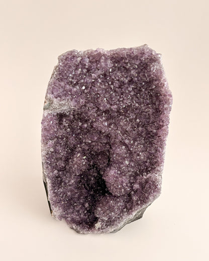 Natural amethyst geode displaying a crystalline interior and distinctive agate banding