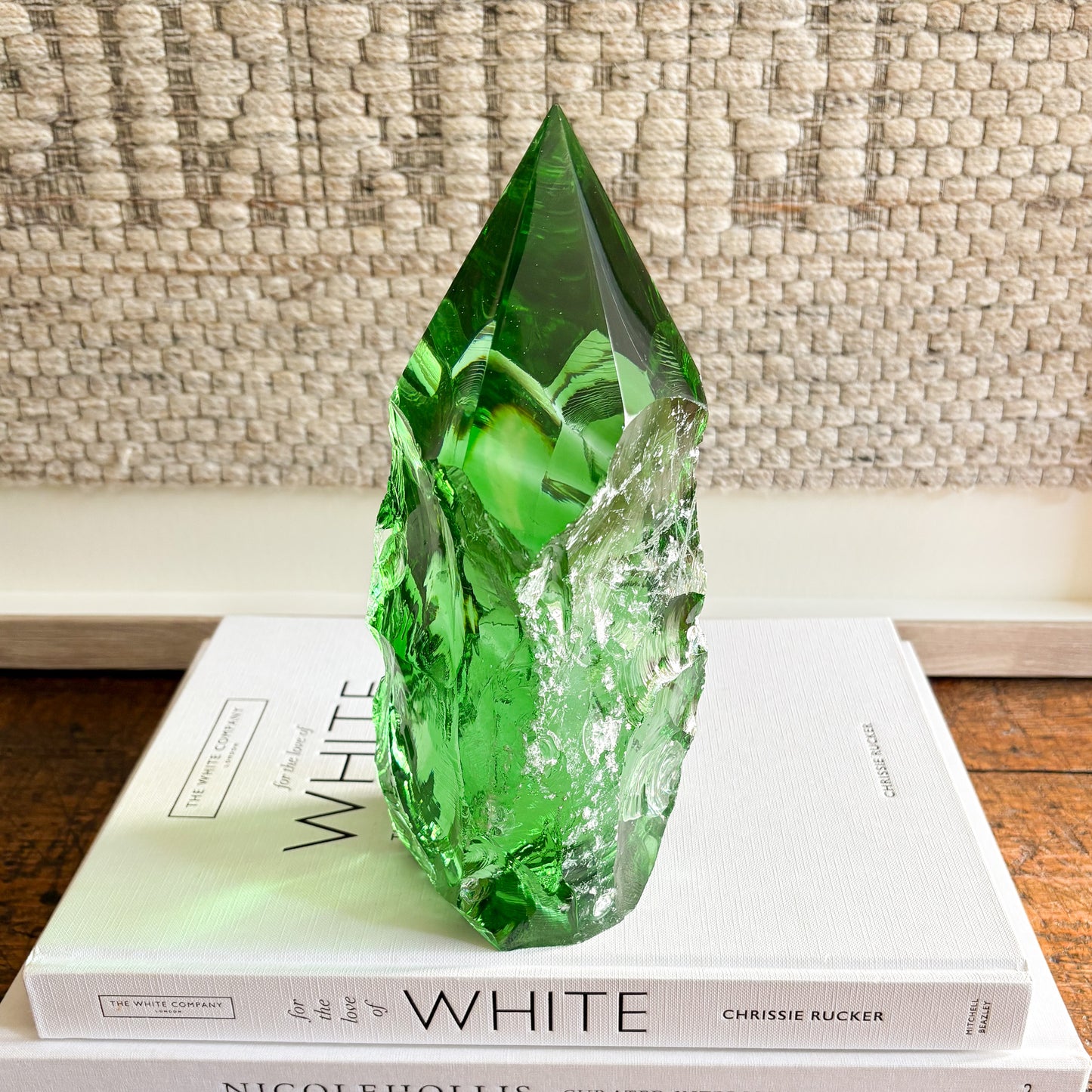 Emerald green glass point decorative object styled for modern shelf or tabletop decor.