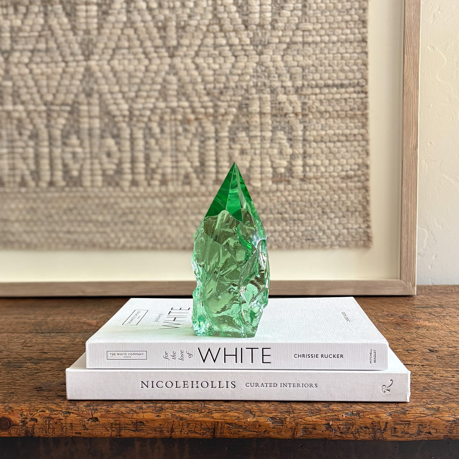 Rustic green glass crystal point styled on neutral decor books