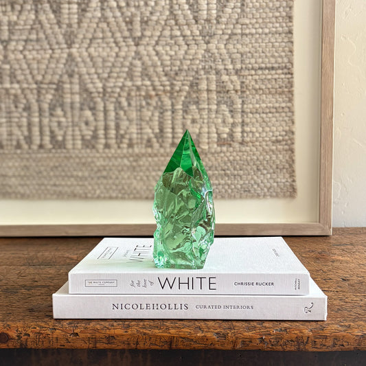 Rustic green glass crystal point styled on neutral decor books