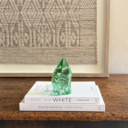 Artisan green glass point styled on White coffee table books
