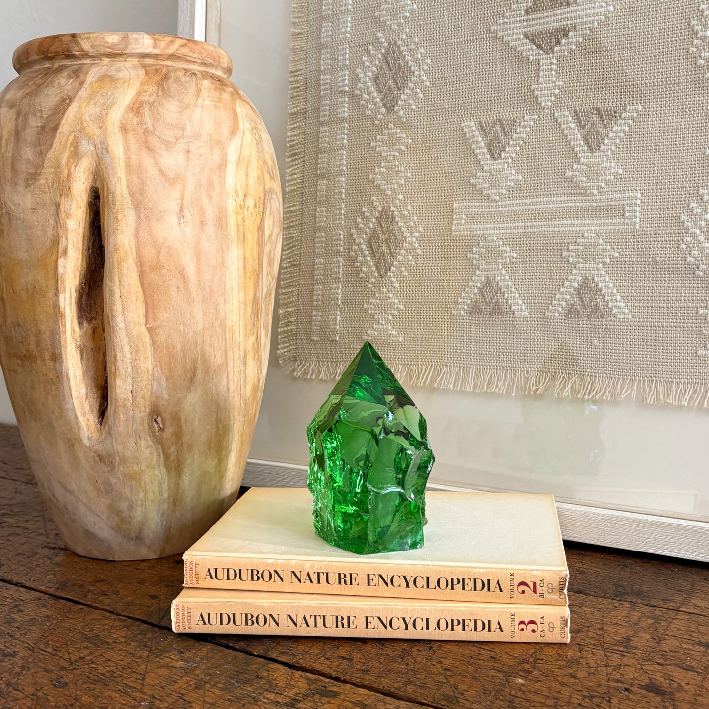 Emerald green glass point home decor styled with vintage book sta