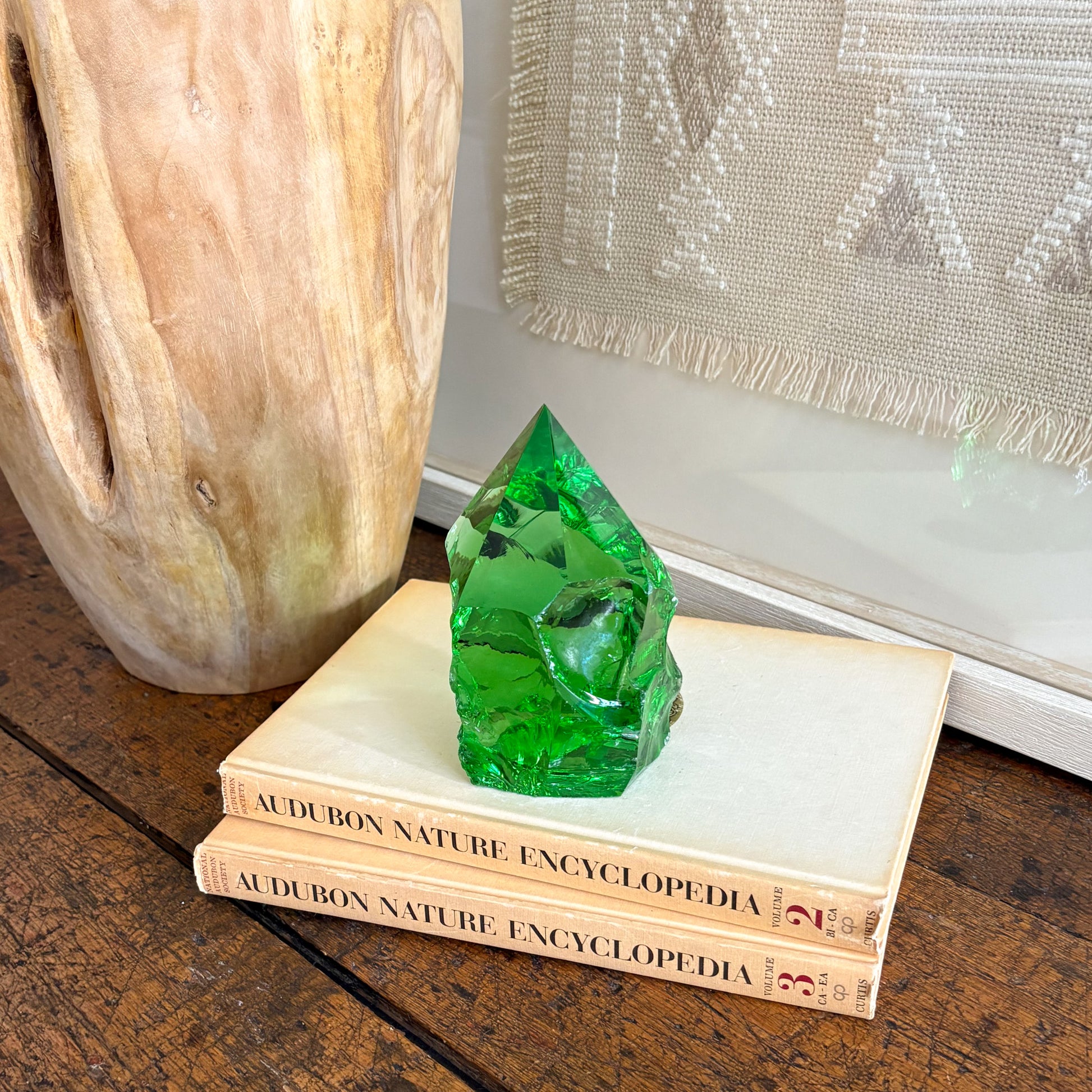 Emerald green glass point home decor styled with vintage book stack