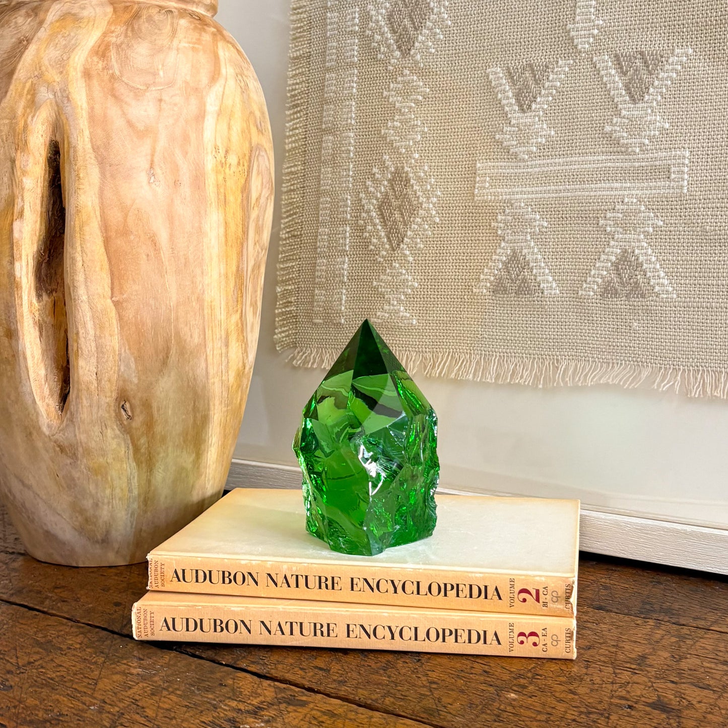 Green glass point crystal decor with carved wood vase and neutral wall hanging
