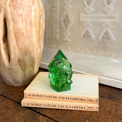 Rustic green glass point displayed on vintage Audubon Nature Encyclopedia books