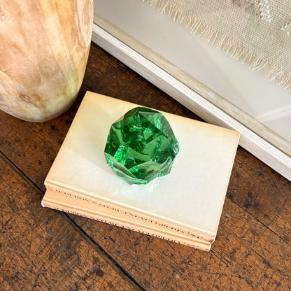 Green glass point tower decor styled with natural wood vase and woven textile