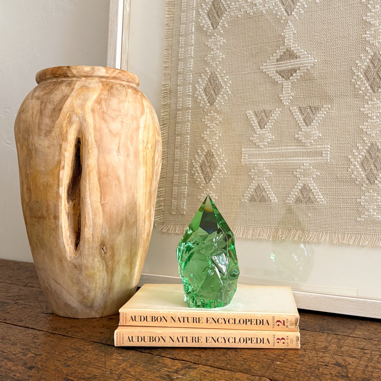 Emerald green glass point home decor styled with vintage book stack