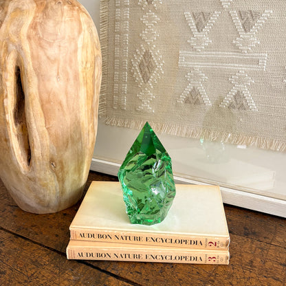 Green glass crystal point centerpiece on book stack with rustic wood vase