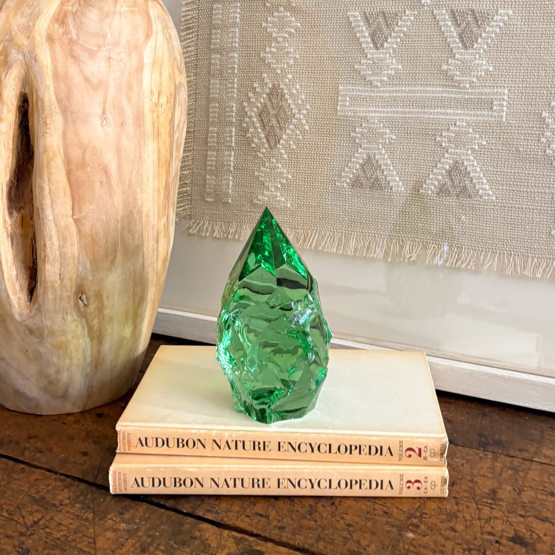 Green glass point crystal decor with carved wood vase and neutral wall hanging