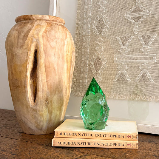 Rustic green glass point displayed on vintage Audubon Nature Encyclopedia books