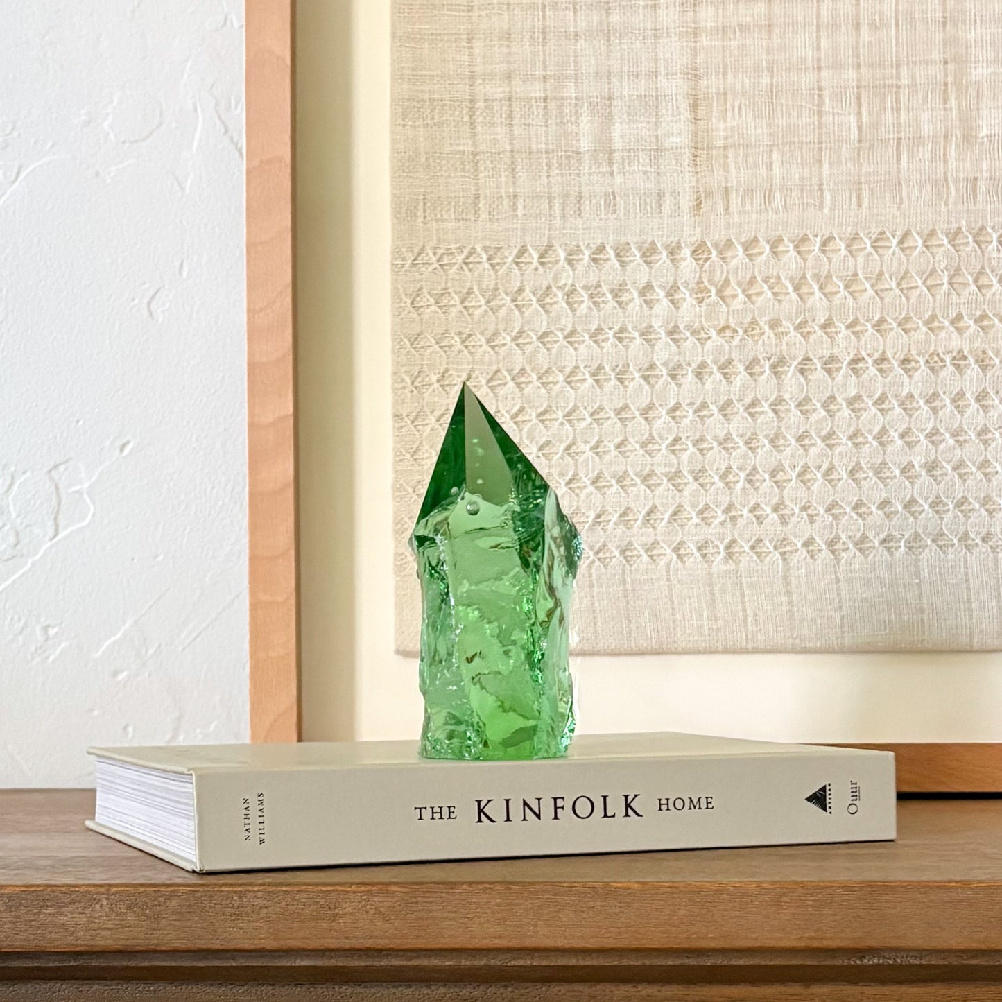 Decorative green glass point on coffee table book, earthy minimalist interior design