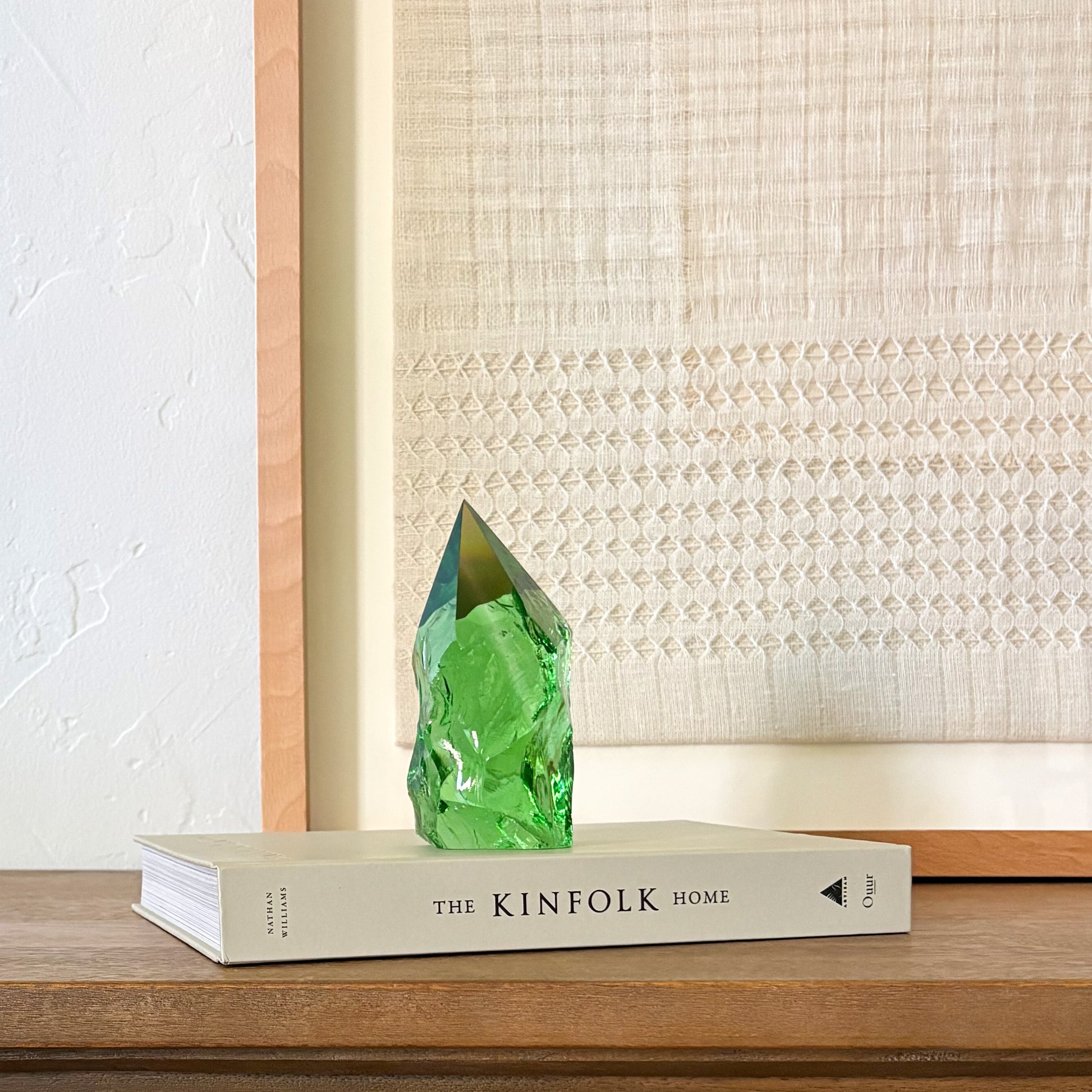 Decorative green glass point on coffee table book, earthy minimalist interior design