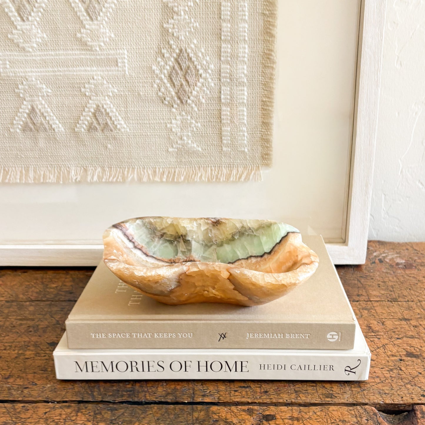 Luxury natural stone bowl with translucent green onyx tones on a neutral interior surface