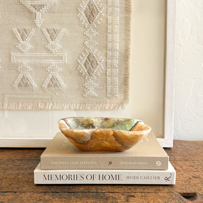 Close-up of serpentine onyx bowl showing natural green banding and polished stone texture