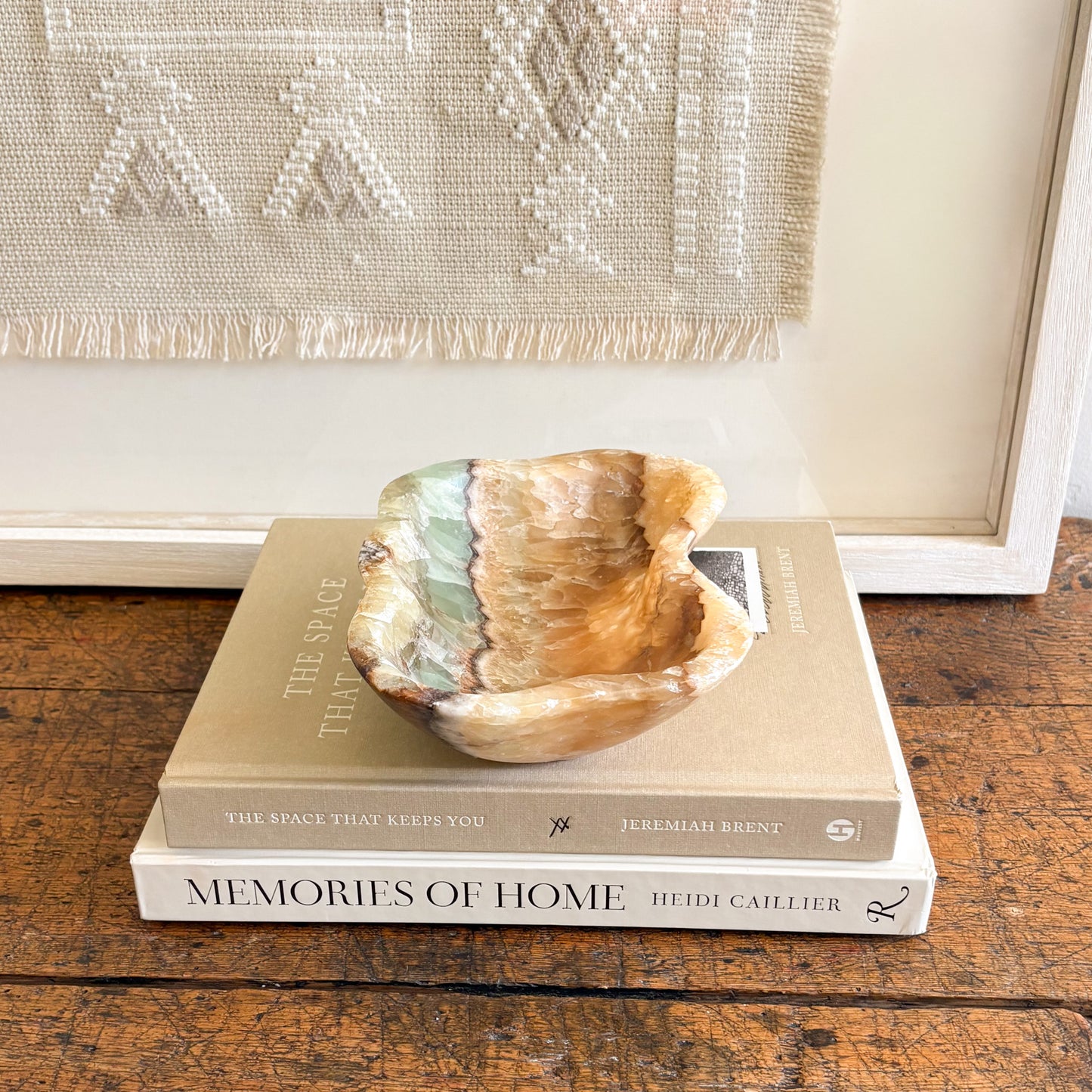 Small serpentine onyx bowl styled as a luxury jewelry dish on a bedside table