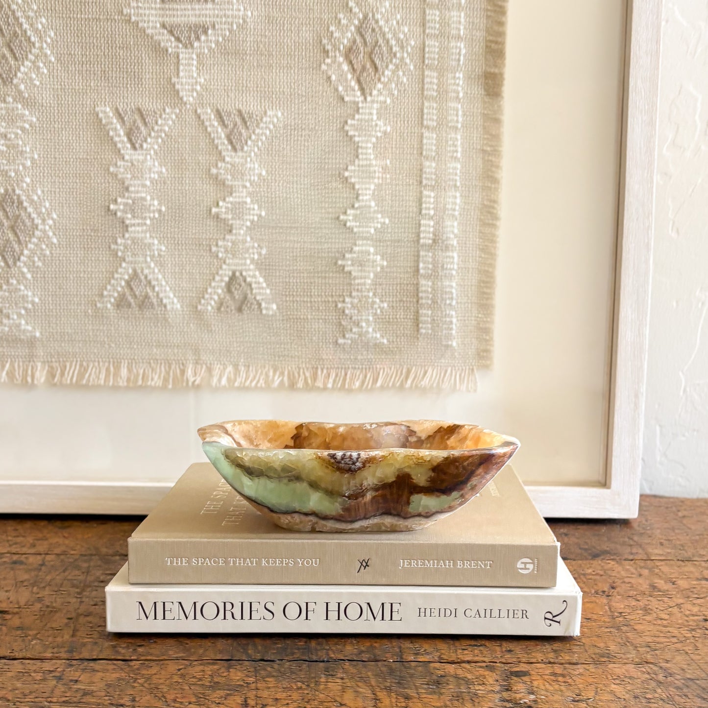 Decorative onyx catchall bowl used for rings and small objects in a modern home