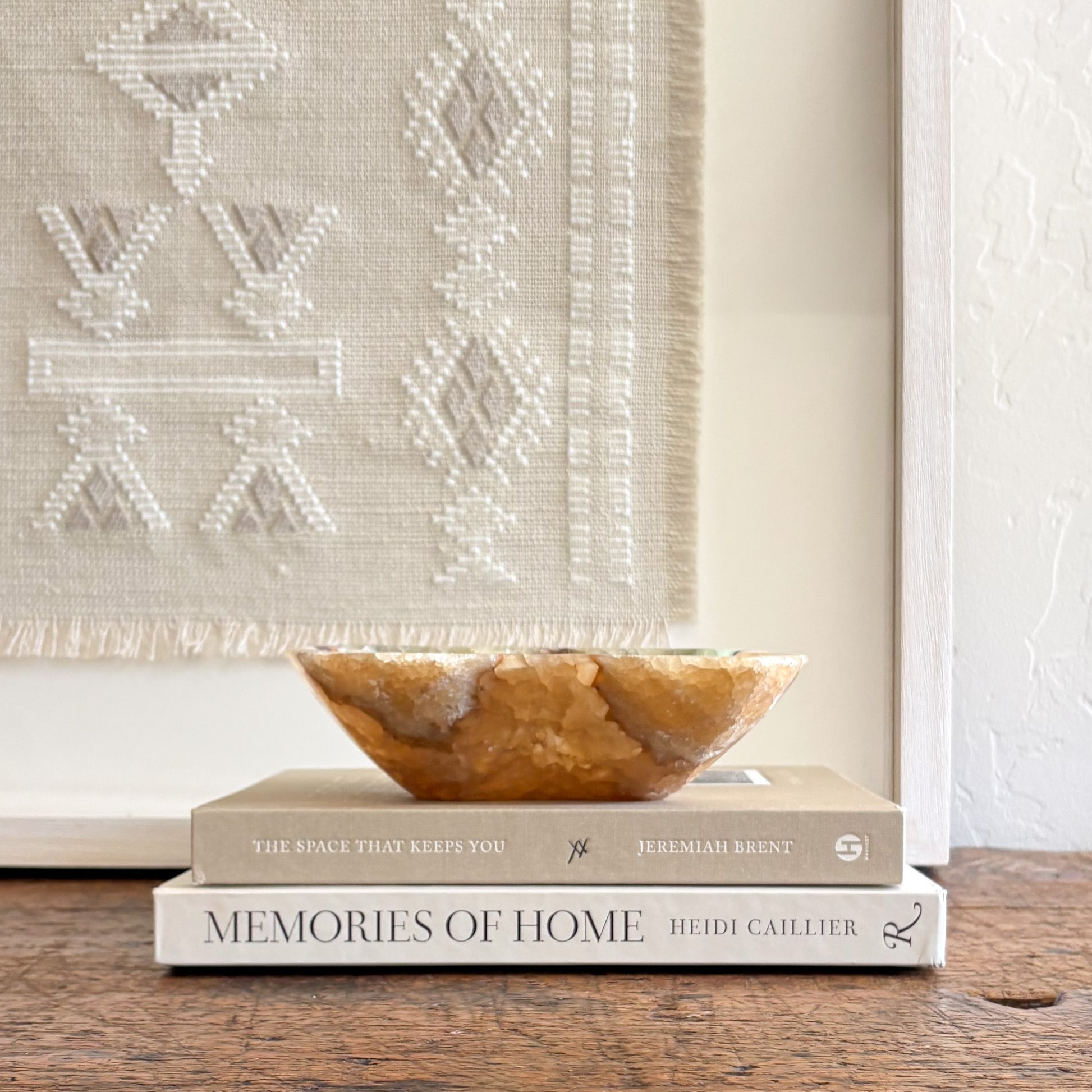Organic stone onyx bowl styled as a luxury accent on a wooden console table