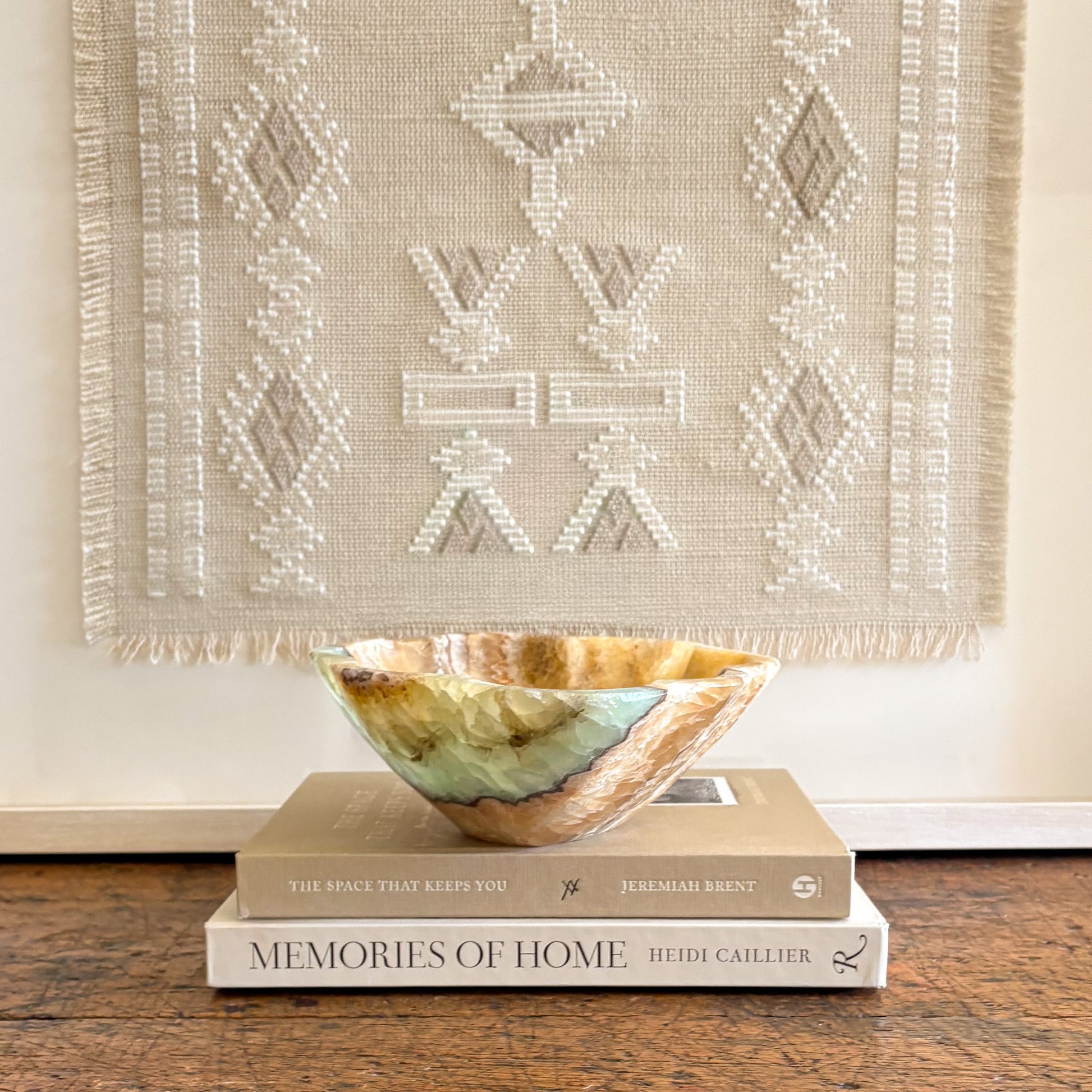 Polished serpentine onyx bowl featuring organic green veining used as a luxury decorative accent