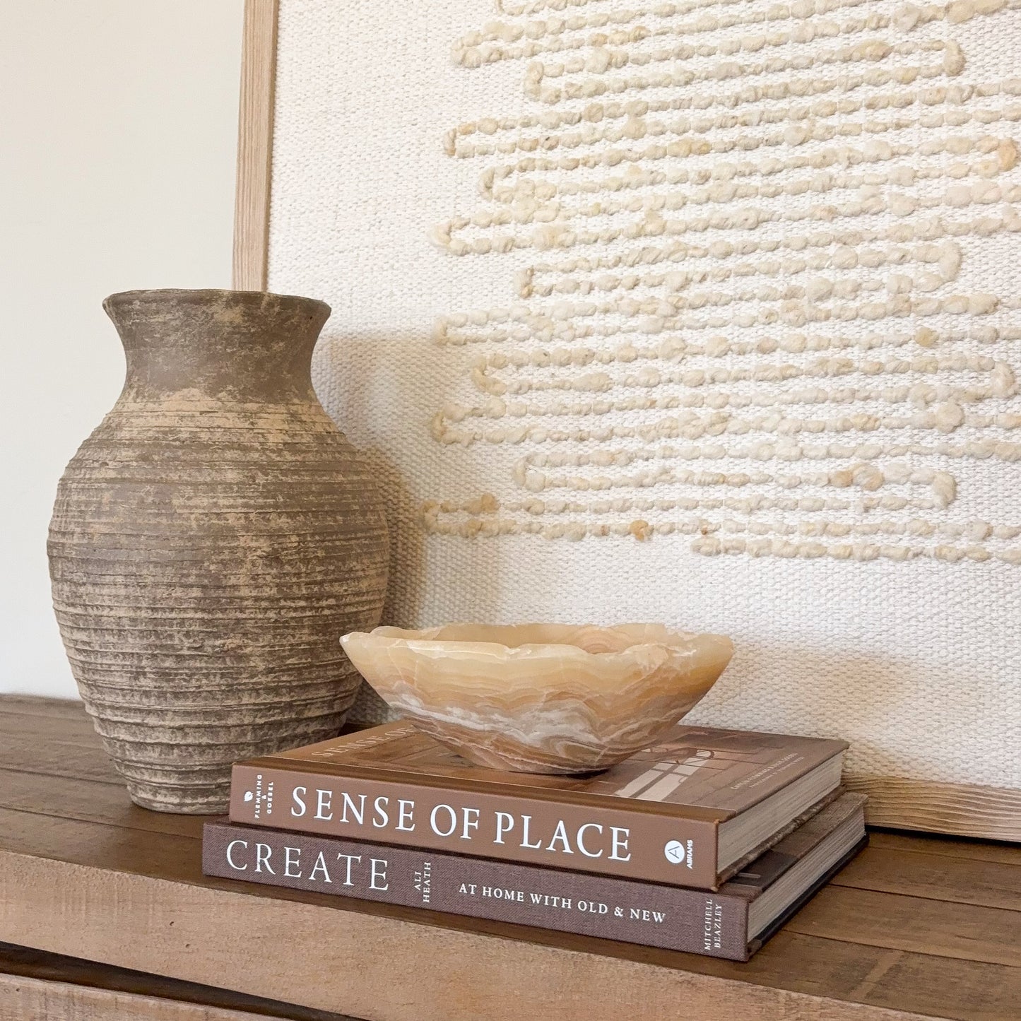 Small amber onyx bowl hand carved from natural stone with warm honey and cream banding