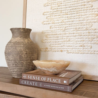 Small amber onyx bowl hand carved from natural stone with warm honey and cream banding