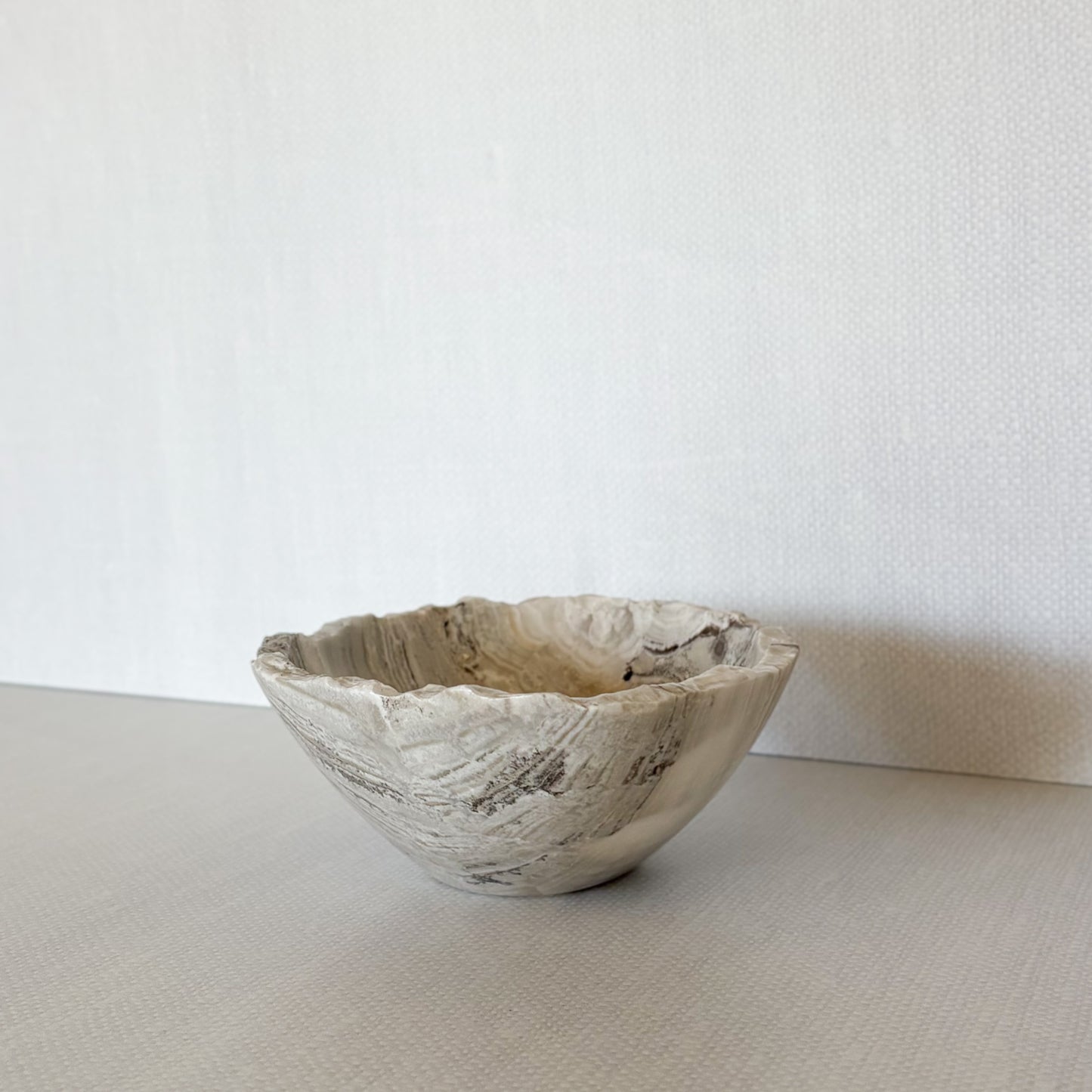 Natural grey onyx bowl used as jewelry catchall