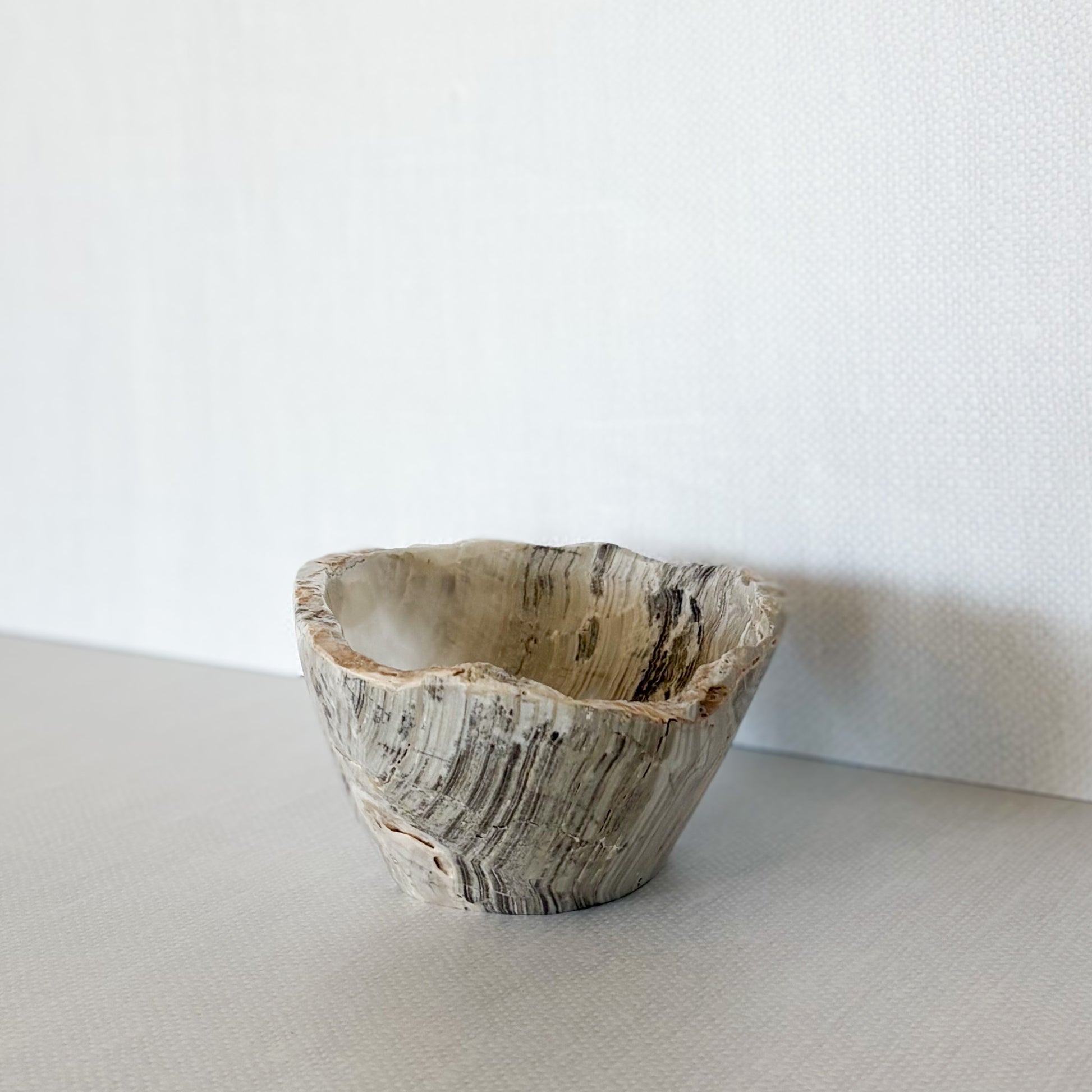 Natural grey onyx bowl used as jewelry catchall