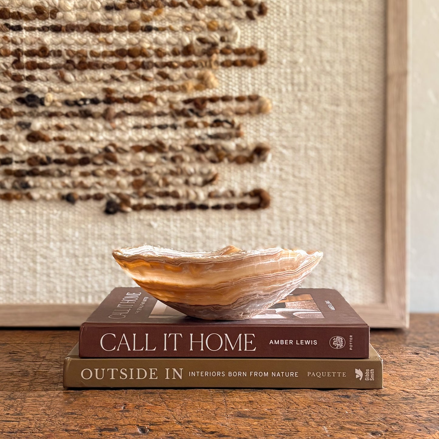 Hand-carved amber onyx bowl styled on books.