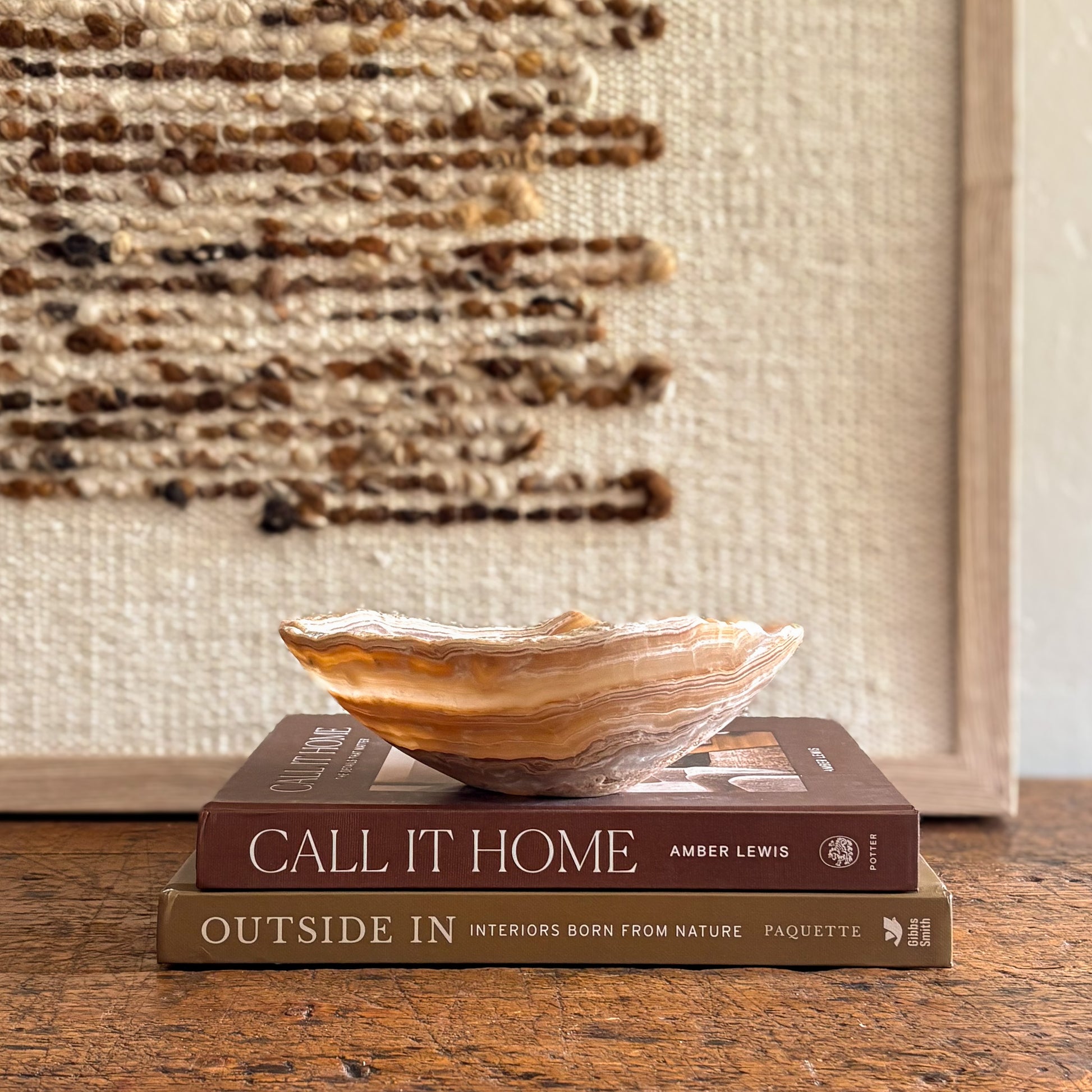 Hand-carved amber onyx bowl styled on books.