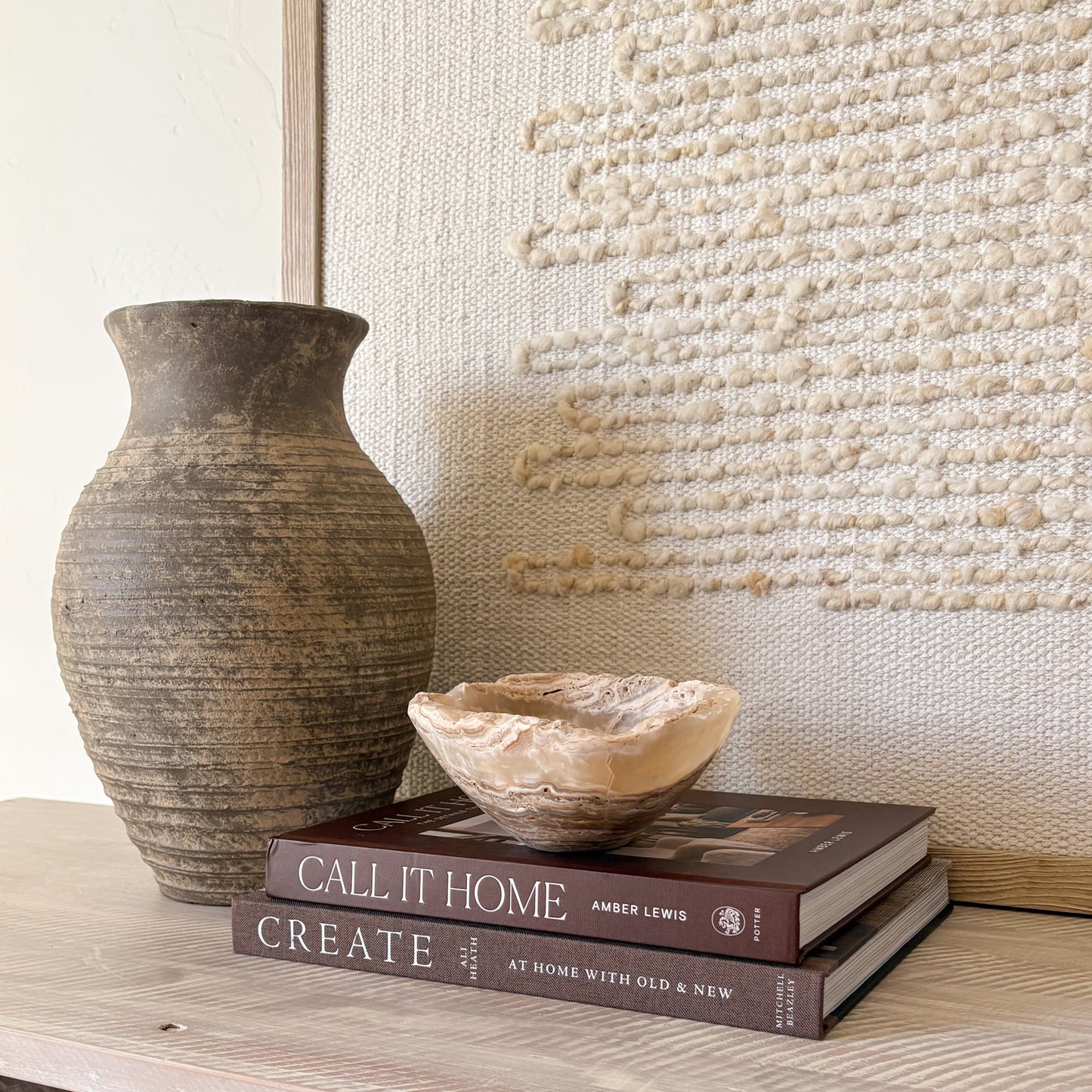 Small hand-carved amber onyx bowl on stacked books