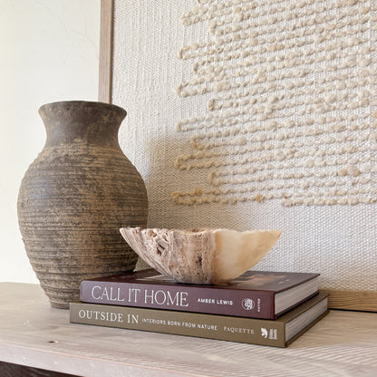 Small hand-carved amber onyx bowl made from natural stone, styled in neutral décor