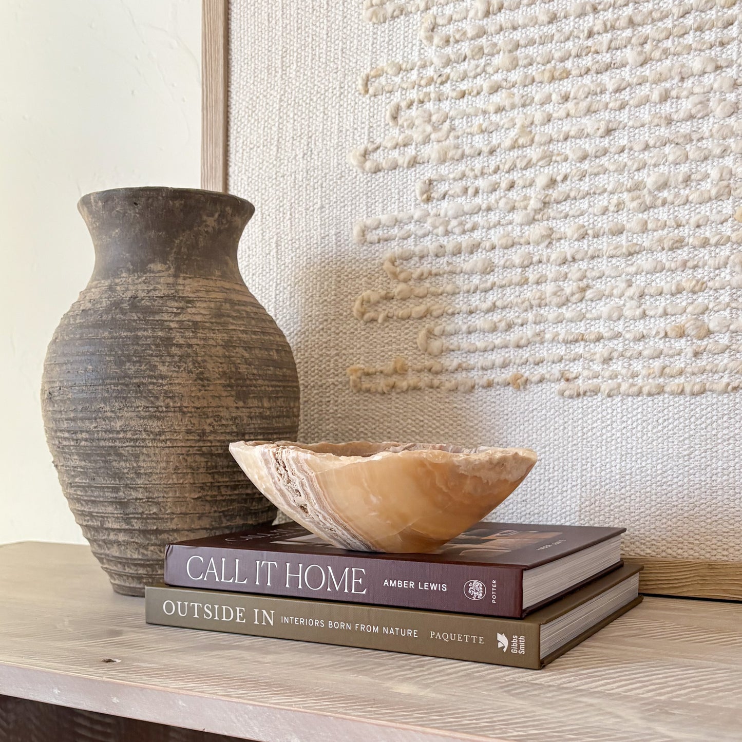 Small hand-carved amber onyx bowl featuring warm golden tones and natural veining