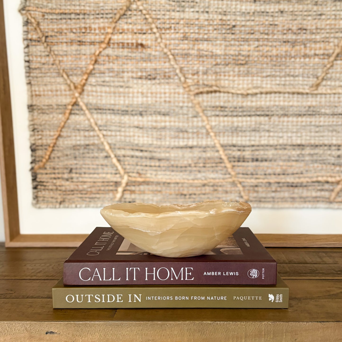 Small polished amber onyx bowl styled on coffee table books