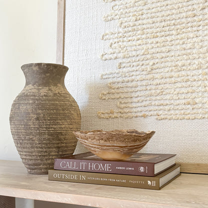 Small polished amber onyx bowl styled on coffee table books