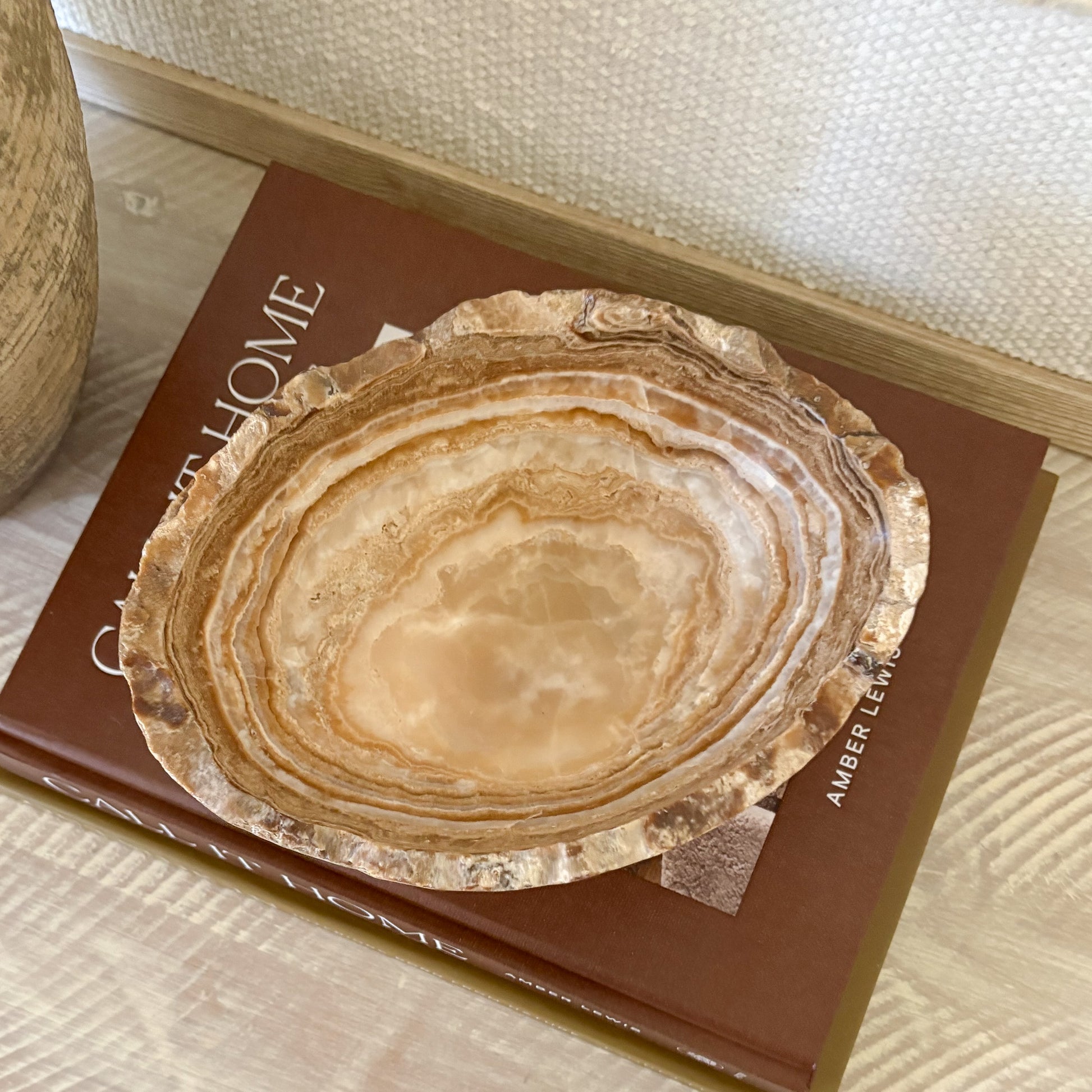 Hand carved amber onyx bowl used as minimalist home decor accent