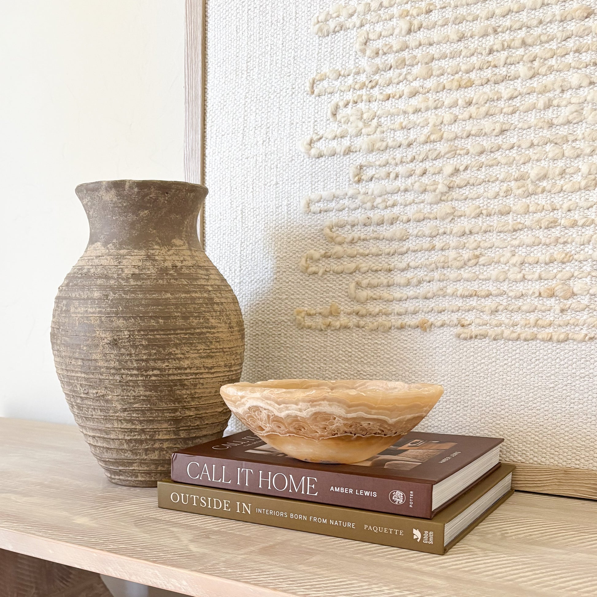 Hand-carved amber onyx bowl styled as luxury home decor on a modern tabletop