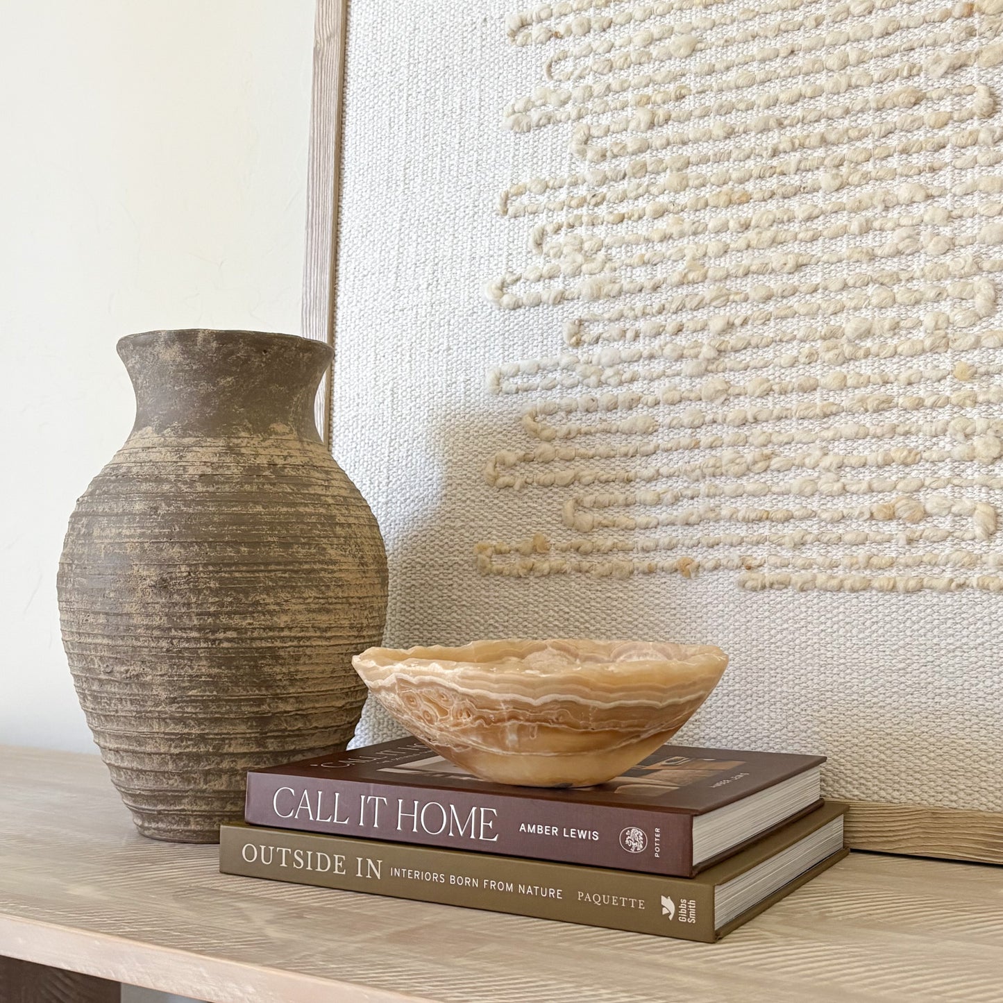 Small amber onyx bowl used as a decorative accent in a luxury interior setting