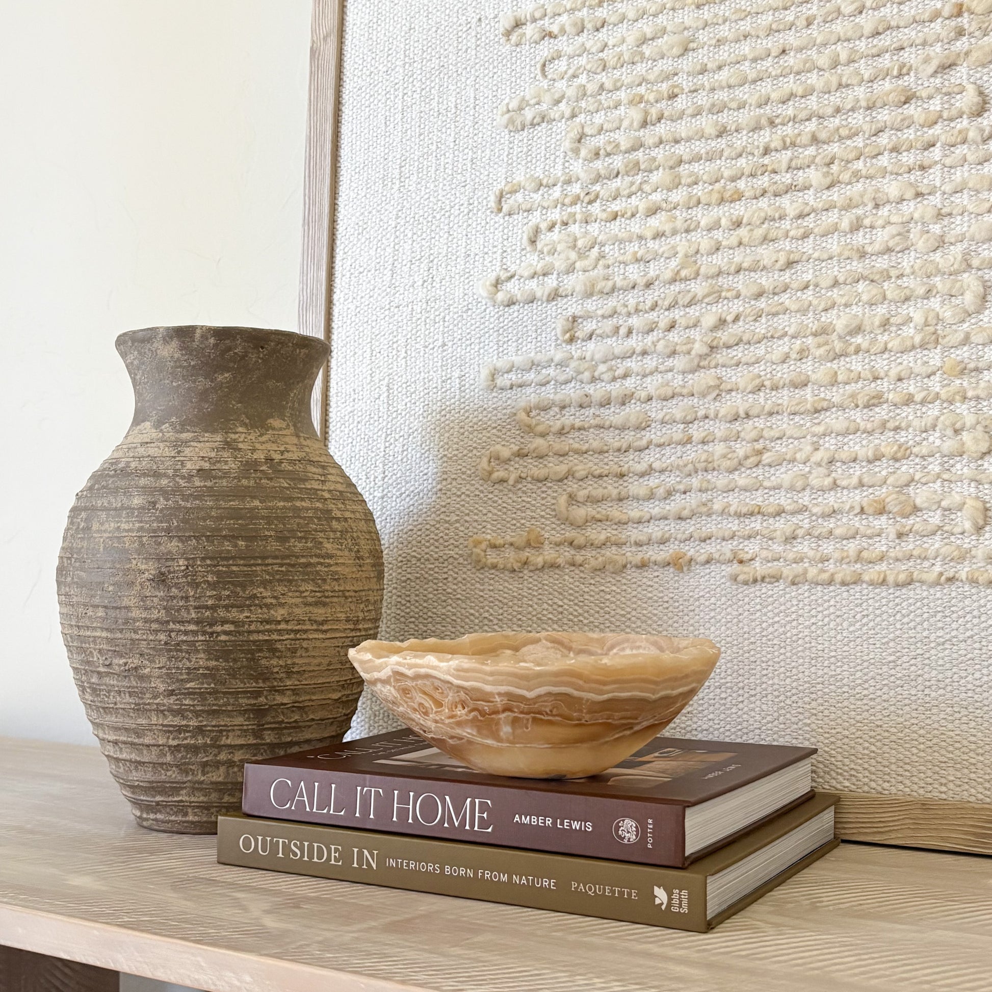 Small amber onyx bowl used as a decorative accent in a luxury interior setting