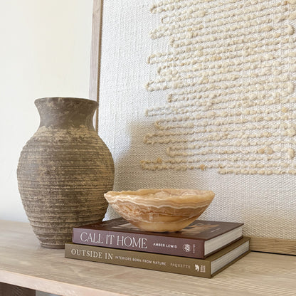 Small amber onyx bowl used as a decorative accent in a luxury interior setting