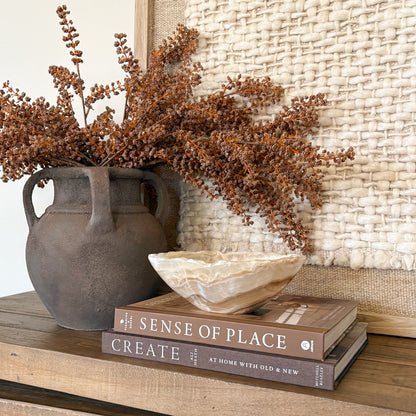 Small amber onyx bowl hand carved from natural stone, decorative tabletop accent