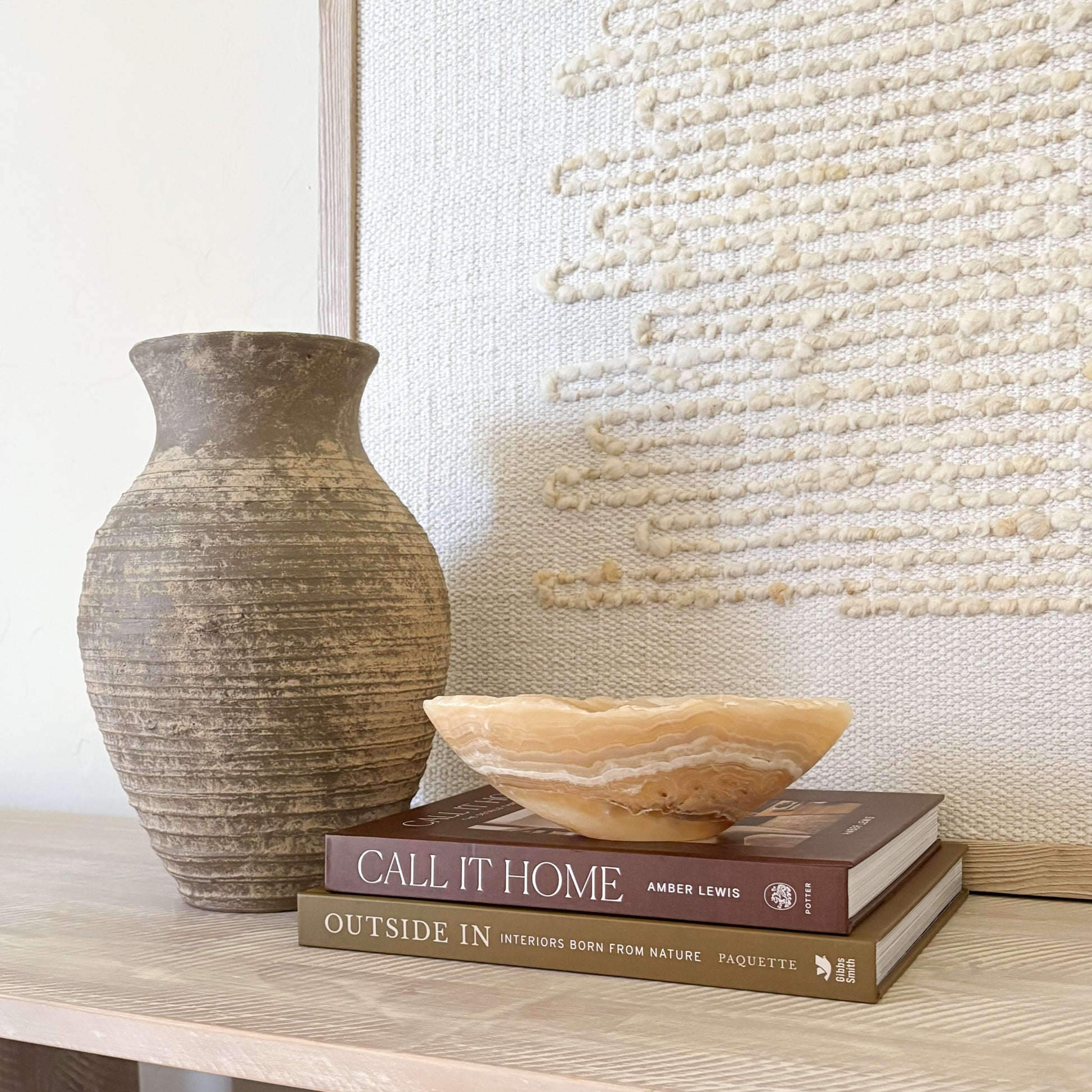 Small amber onyx bowl used as a decorative accent in a luxury interior setting