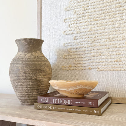 Small amber onyx bowl used as a decorative accent in a luxury interior setting