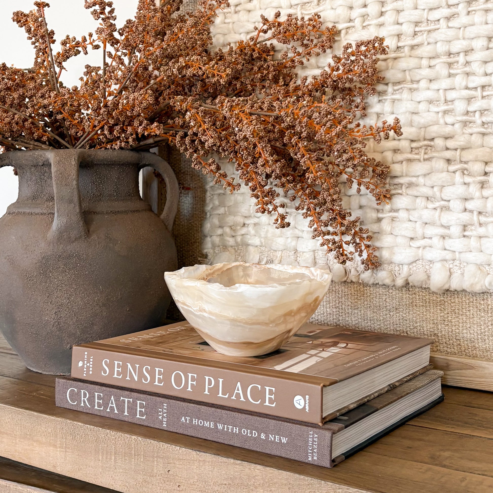 Hand carved amber onyx stone bowl with warm golden tones, artisan decor piece