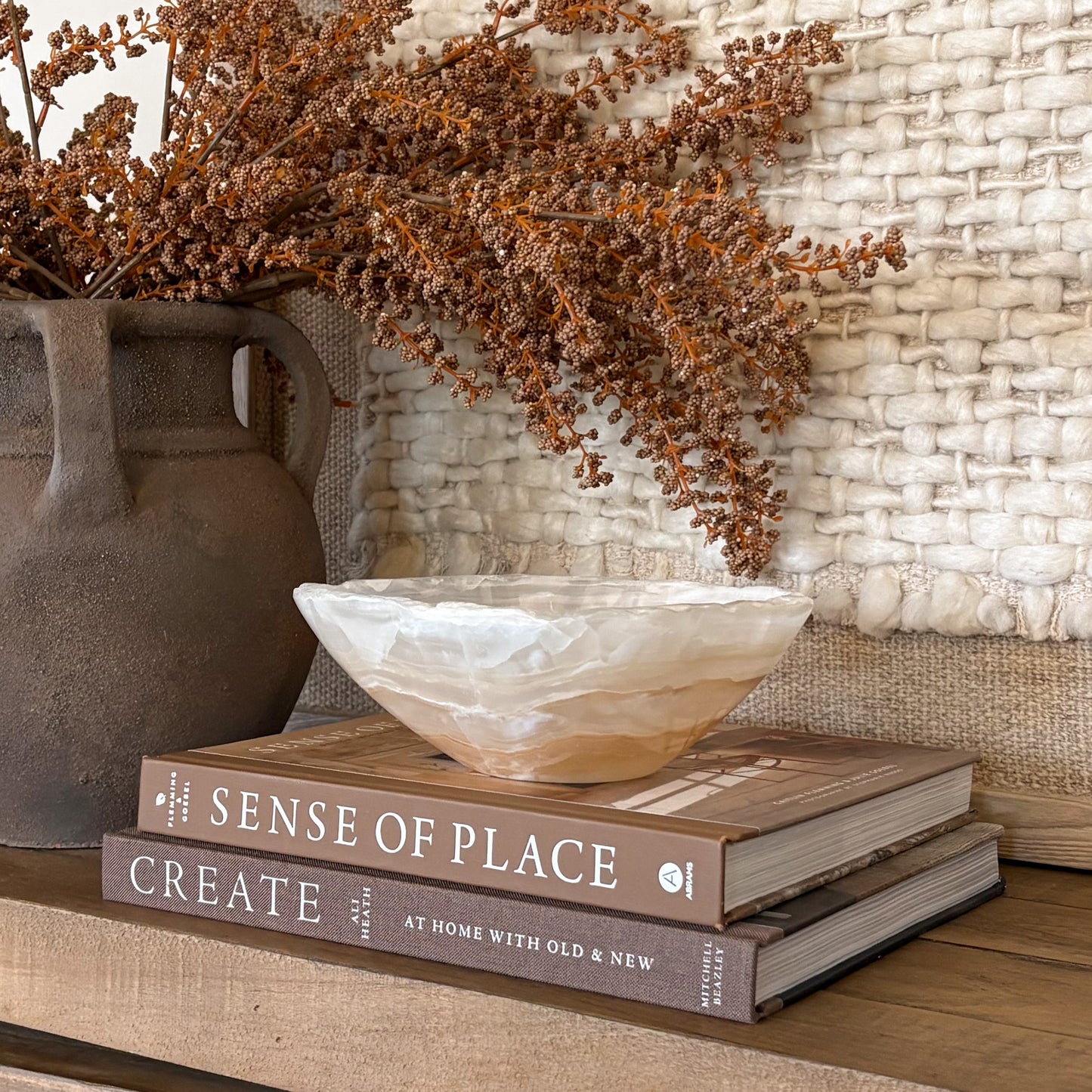 Hand carved amber onyx stone bowl with warm golden tones, artisan decor piece