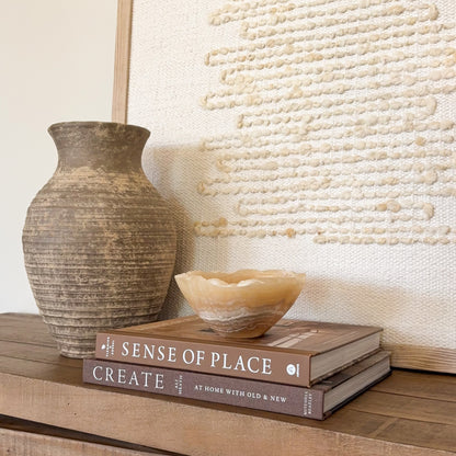 Handcrafted amber onyx stone bowl with smooth finish and natural mineral veining