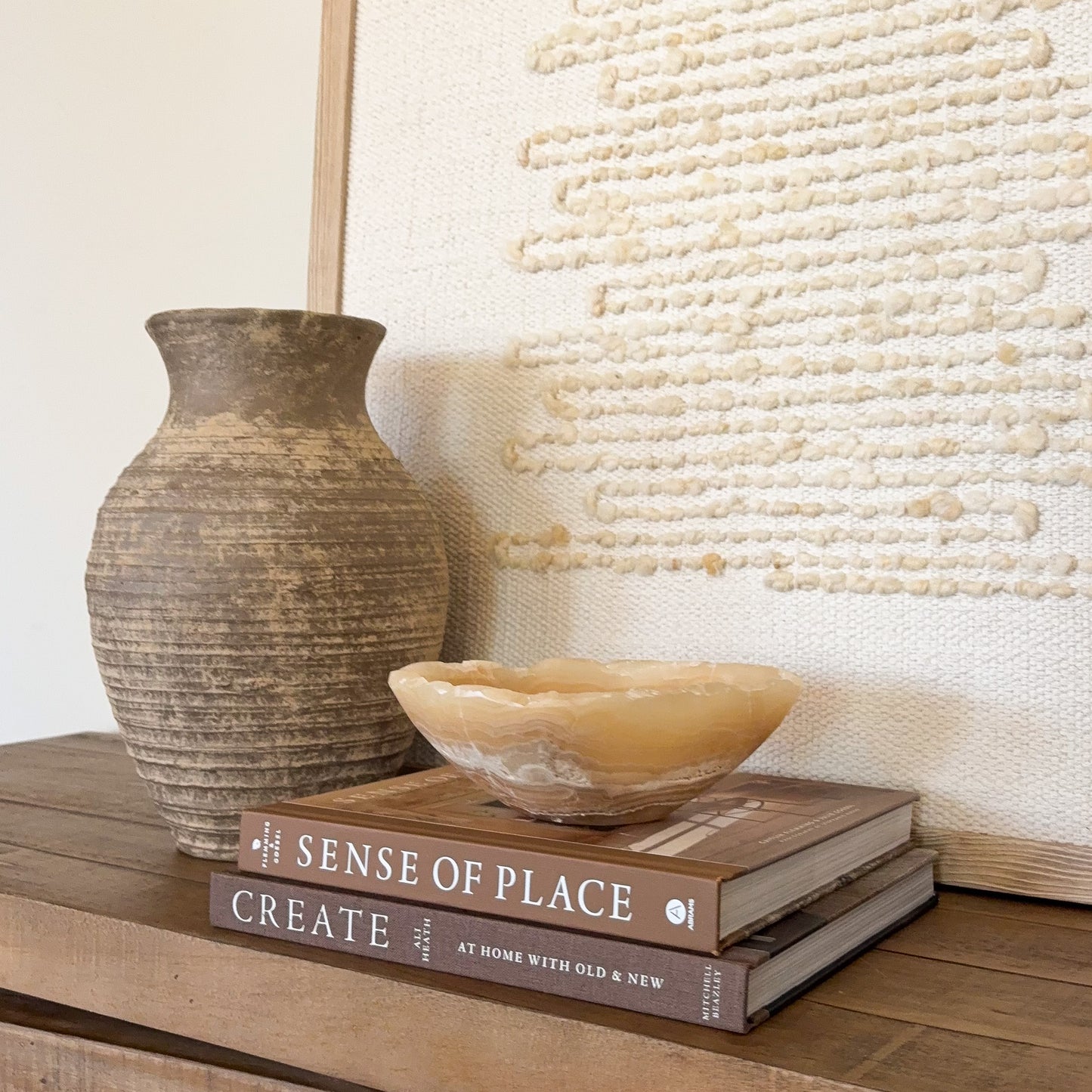 Polished small onyx crystal bowl in amber tones for decorative tabletop display