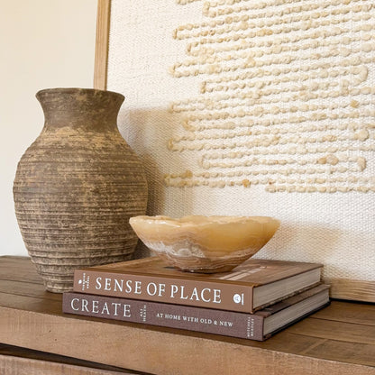 Artisan carved small onyx bowl in golden amber stone