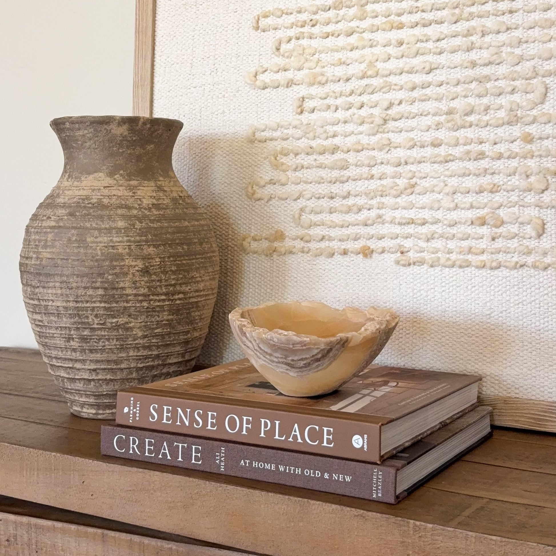 Small luxury onyx bowl carved from natural amber stone for shelf styling