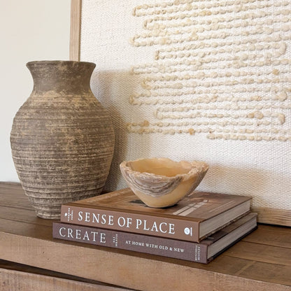 Small luxury onyx bowl carved from natural amber stone for shelf styling